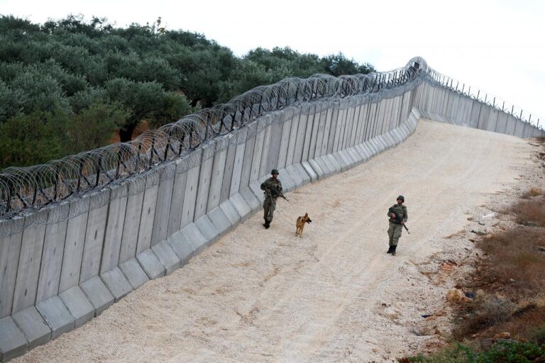 A K9 unit patrol along a wall on the border line between Turkey and Syria, near the southeastern village of Besarslan in Hatay province