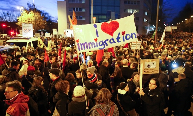 People gather to take part in a protest against the march of a grass-roots anti-Muslim movement in Cologne
