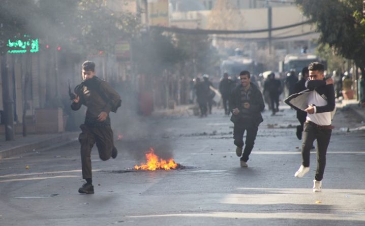 Kurdish protesters run away from tear gaz during a rally against the Kurdistan Regional Government (KRG) in Sulaimaniyah