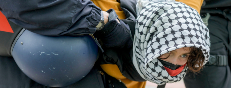 A-woman-is-carried-away-by-police-officers-during-a-pro-Palestinians-demonstration-by-the-group-Student-Coalition-Berlin-in-the-theater-courtyard-of-the-Freie-Universitat-Berlin-university-in-Be